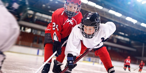 Register for Classes - Two boys vying for the puck